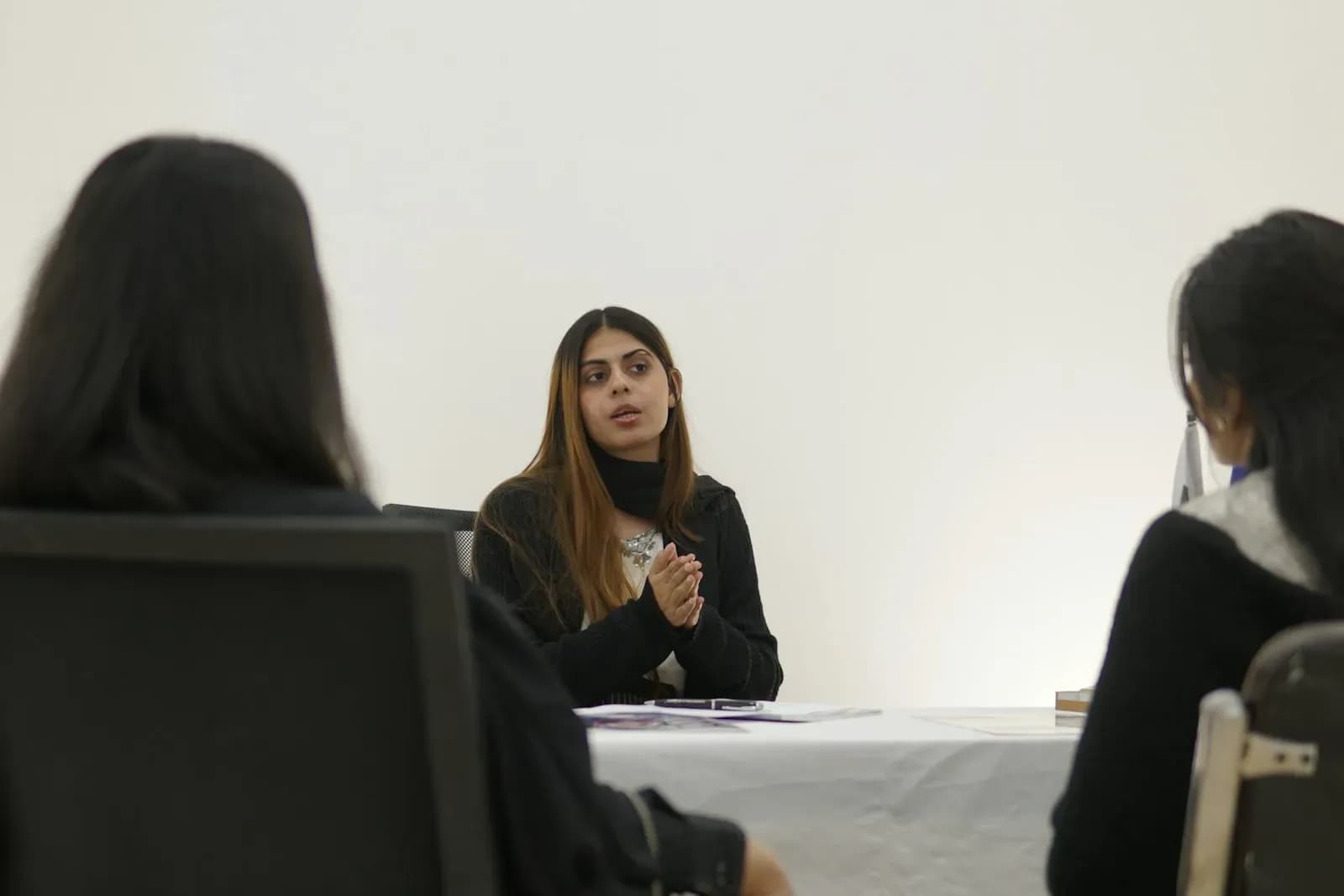 Two people talking across a table during an interview