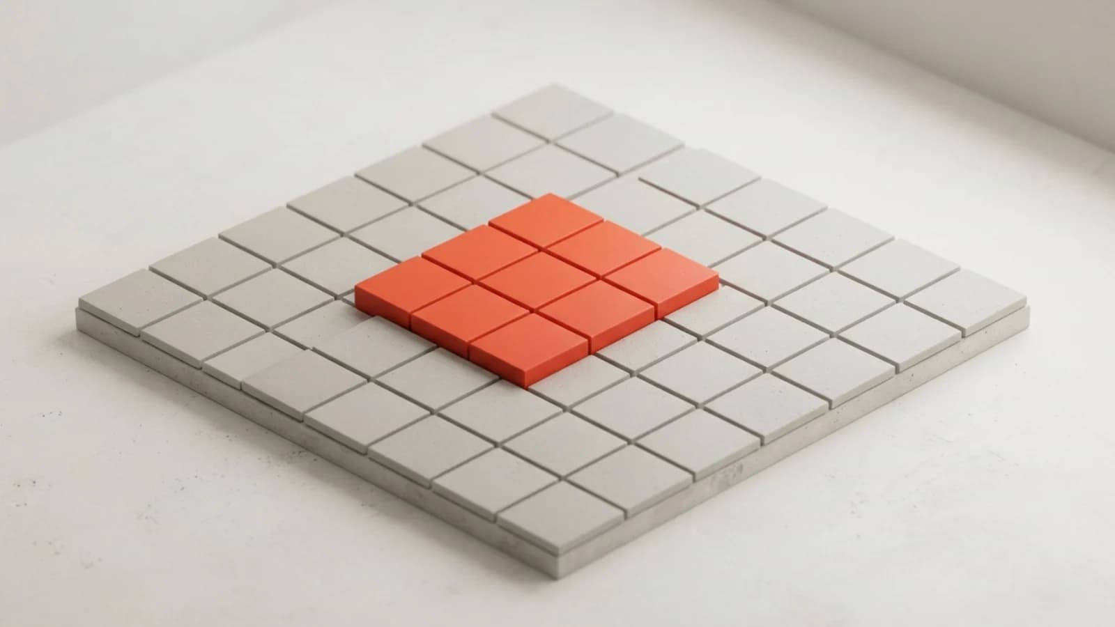 A grid of grey tiles with a raised block of orange tiles